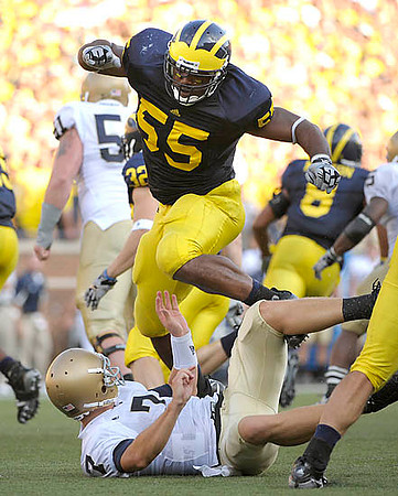 Jordan Kovacs (32), Brandon Graham (55), and Jonas Mouton (8)