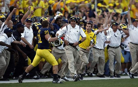 Jordan Reilly (21) and Rich Rodriguez