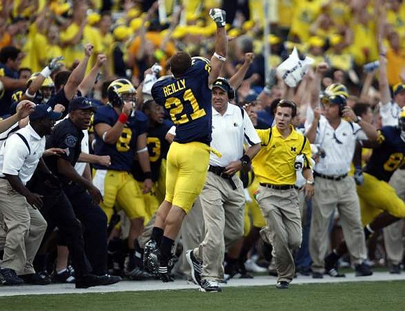 Jordan Reilly (21) and Rich Rodriguez