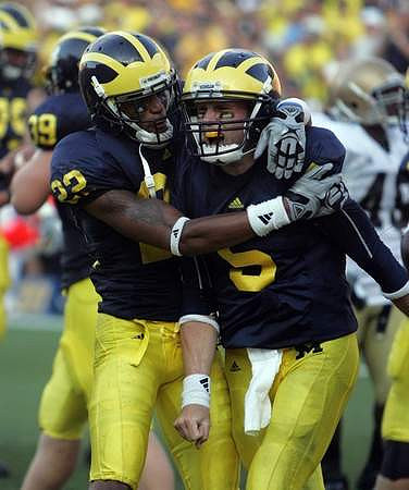 Will Heininger (39), Darryl Stonum (22), and Tate Forcier (5)