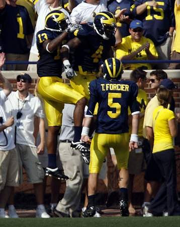 Greg Mathews (13) and Tate Forcier (5)