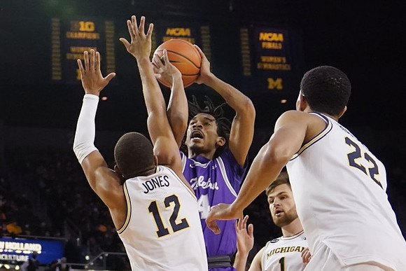 DeVante' Jones (12), Hunter Dickinson (1), and Caleb Houstan (22)