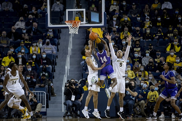 Moussa Diabate (14), Caleb Houstan (22), and Terrance Williams II (5)