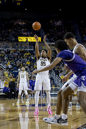 Brandon Johns Jr. (23) and Eli Brooks (55)