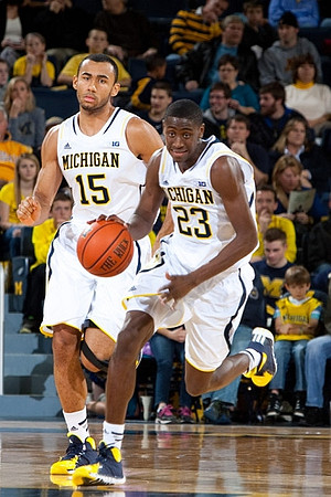 Jon Horford (15) and Caris LeVert (23)