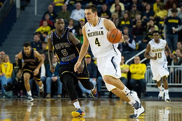 Mitch McGary (4) and Derrick Walton Jr. (10)