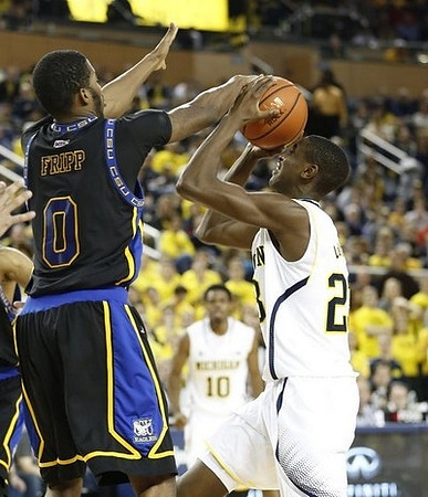 Derrick Walton Jr. (10) and Caris LeVert (23)