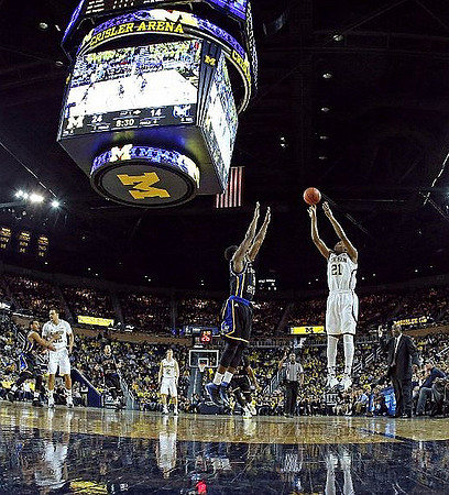 Jordan Morgan (52), Spike Albrecht (2), Zak Irvin (21), and Coppin State Head Coach Ron Mitchell