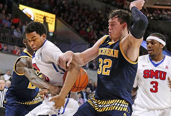 Caris LeVert (23) and Ricky Doyle (32)