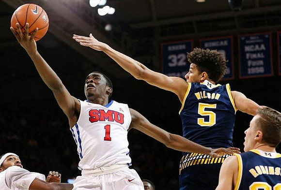 D.J. Wilson (5) and Duncan Robinson (22)