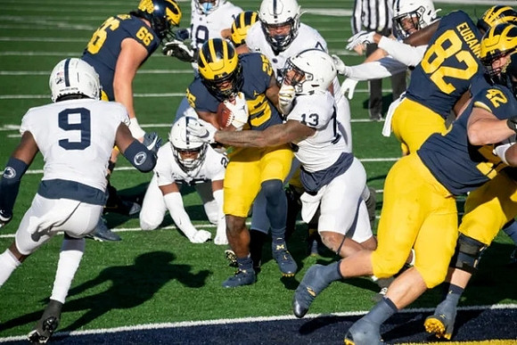 Chuck Filiaga (66), Hassan Haskins (25), Nick Eubanks (82), and Ben Mason (42)