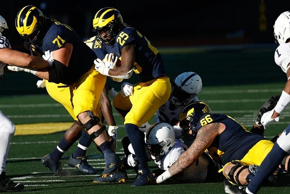 Andrew Stueber (71), Hassan Haskins (25), and Chuck Filiaga (66)