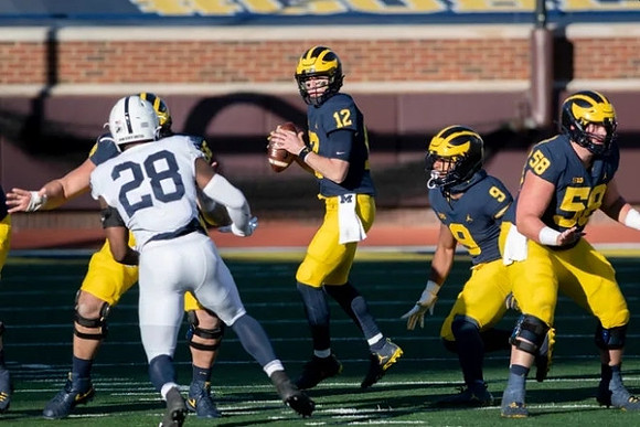 Cade McNamara (12), Chris Evans (9), and Zach Carpenter (58)