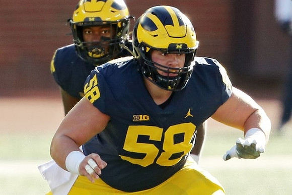 Hassan Haskins (25) and Zach Carpenter (58)