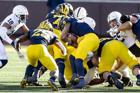 Hassan Haskins (25), Trevor Keegan (77), and Joe Milton (5)