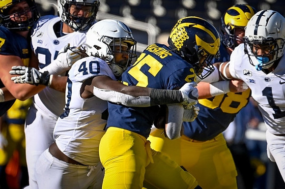 Hassan Haskins (25) and Zach Carpenter (58)