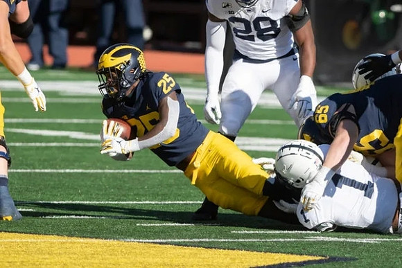 Hassan Haskins (25) and Zak Zinter (65)