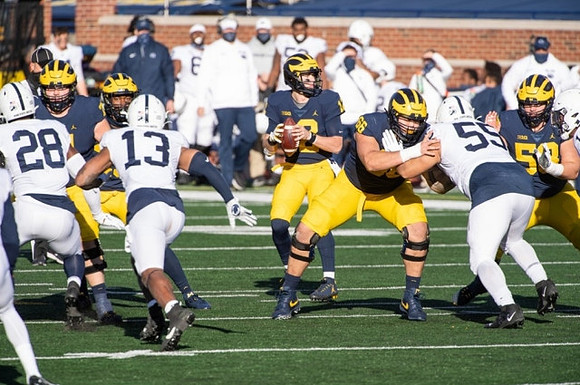 Cade McNamara (12), Chuck Filiaga (66), and Zach Carpenter (58)