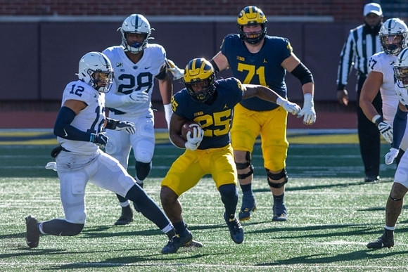 Hassan Haskins (25) and Andrew Stueber (71)