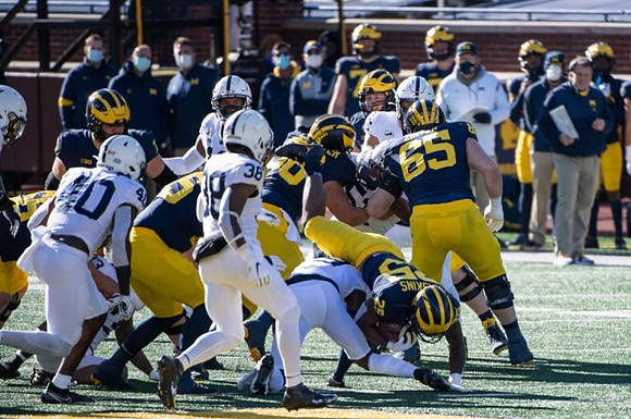 Hassan Haskins (25) and Zak Zinter (65)