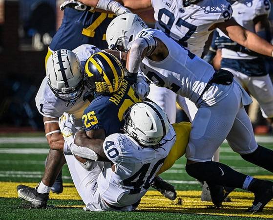 Trevor Keegan (77) and Hassan Haskins (25)