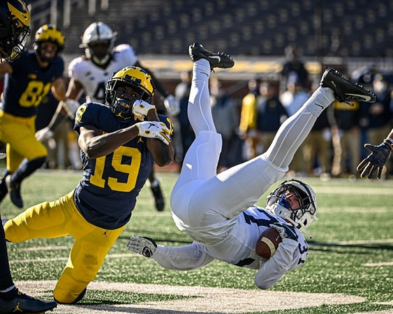 Nate Schoenle (81) and Mike Sainristil (19)