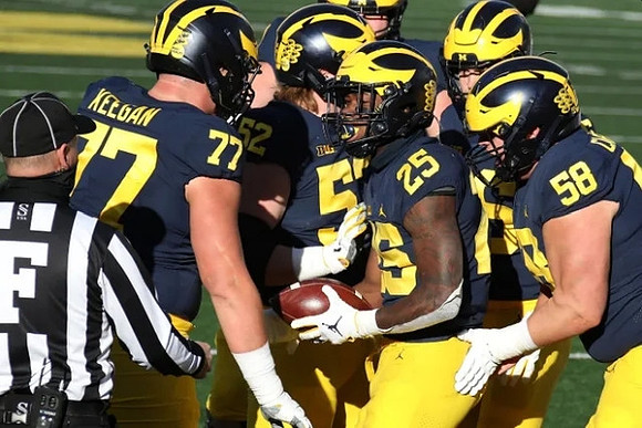 Trevor Keegan (77), Karsen Barnhart (52), Hassan Haskins (25), and Zach Carpenter (58)