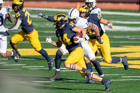 Hassan Haskins (25), Roman Wilson (14), and Erick All (83)