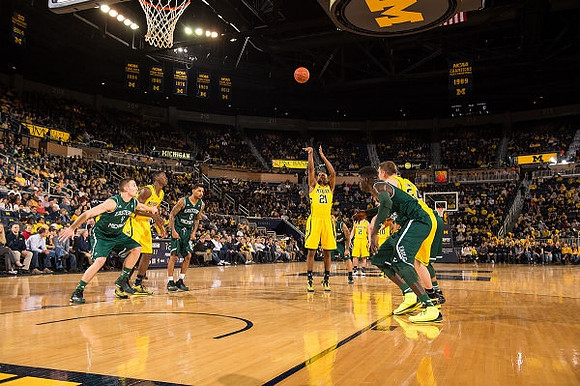 Caris LeVert (23), Zak Irvin (21), Spike Albrecht (2), Mark Donnal (34), and Derrick Walton Jr. (10)