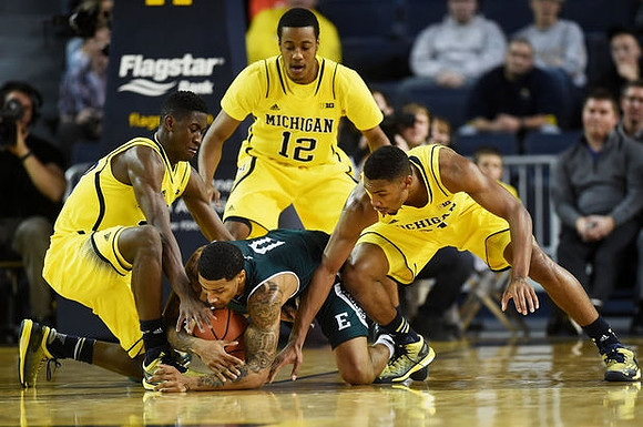 Caris LeVert (23), Muhammad-Ali Abdur-Rahkman (12), and Zak Irvin (21)