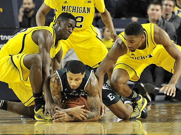 Caris LeVert (23), Ricky Doyle (32), and Zak Irvin (21)