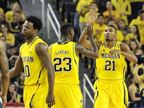 Derrick Walton Jr. (10), Caris LeVert (23), and Zak Irvin (21)