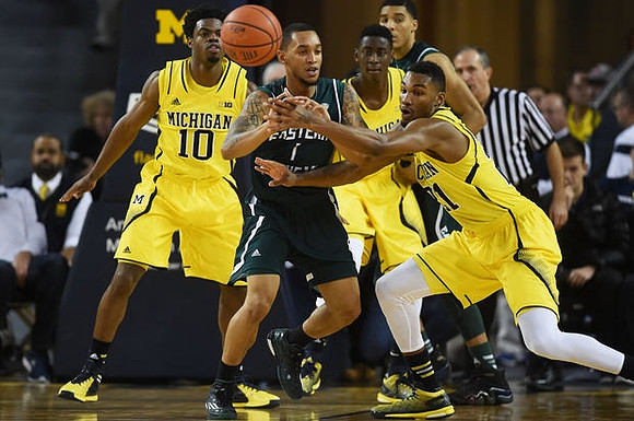Derrick Walton Jr. (10), Caris LeVert (23), and Zak Irvin (21)