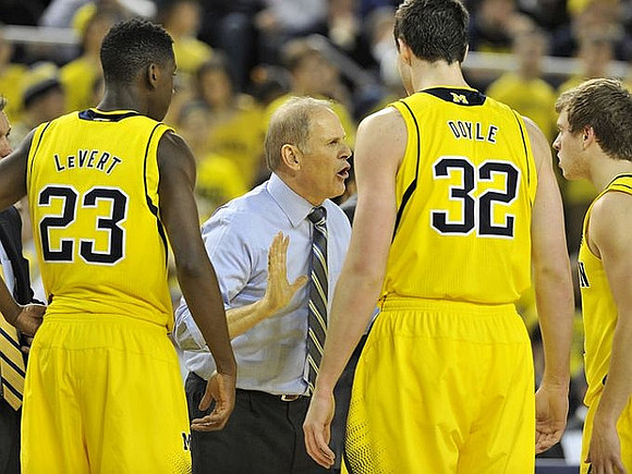Caris LeVert (23), John Beilein, Ricky Doyle (32), and Spike Albrecht (2)