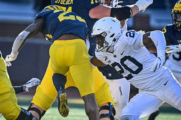 Hassan Haskins (25) and Andrew Stueber (71)