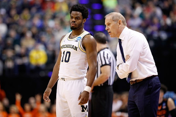 Derrick Walton Jr. (10) and John Beilein