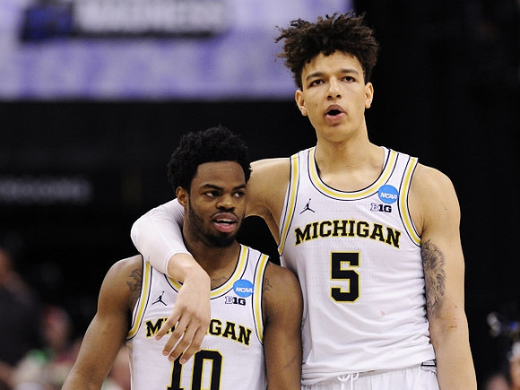 Derrick Walton Jr. (10) and D.J. Wilson (5)