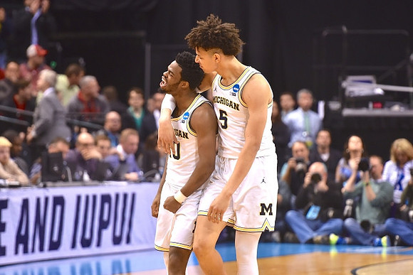Derrick Walton Jr. (10) and D.J. Wilson (5)