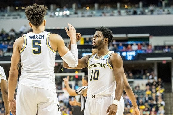 D.J. Wilson (5) and Derrick Walton Jr. (10)