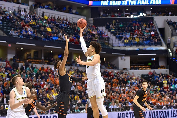 Moritz Wagner (13) and D.J. Wilson (5)