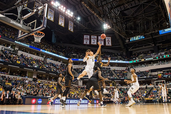 D.J. Wilson (5), Derrick Walton Jr. (10), Zak Irvin (21), and Xavier Simpson (3)