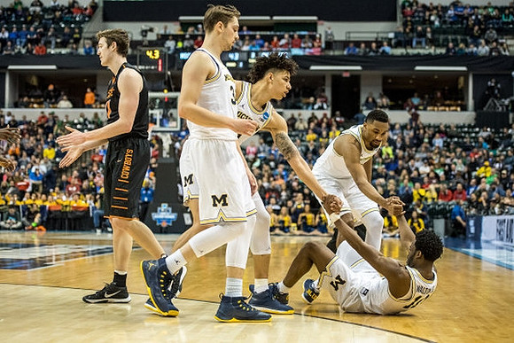 Ibi Watson (23), D.J. Wilson (5), Zak Irvin (21), and Derrick Walton Jr. (10)