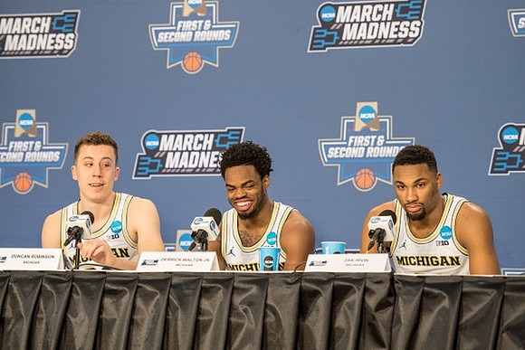 Duncan Robinson (22), Derrick Walton Jr. (10), and Zak Irvin (21)