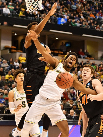D.J. Wilson (5) and Derrick Walton Jr. (10)