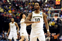 Zak Irvin (21), D.J. Wilson (5), and Derrick Walton Jr. (10)
