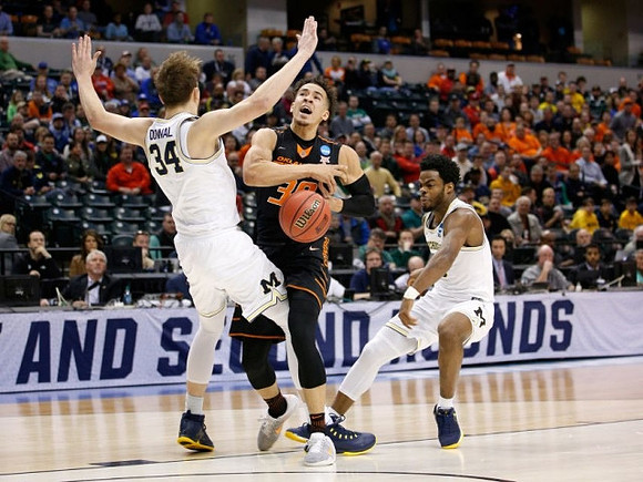 Mark Donnal (34) and Derrick Walton Jr. (10)