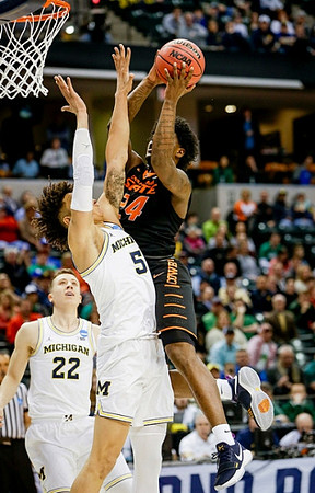 Duncan Robinson (22) and D.J. Wilson (5)