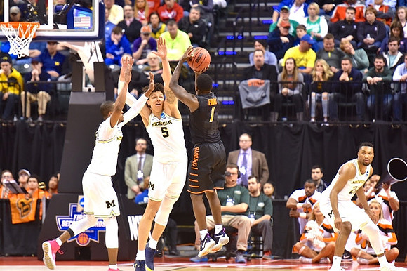 Muhammad-Ali Abdur-Rahkman (12), D.J. Wilson (5), and Zak Irvin (21)