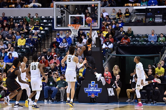 Zak Irvin (21), Derrick Walton Jr. (10), D.J. Wilson (5), and Muhammad-Ali Abdur-Rahkman (12)