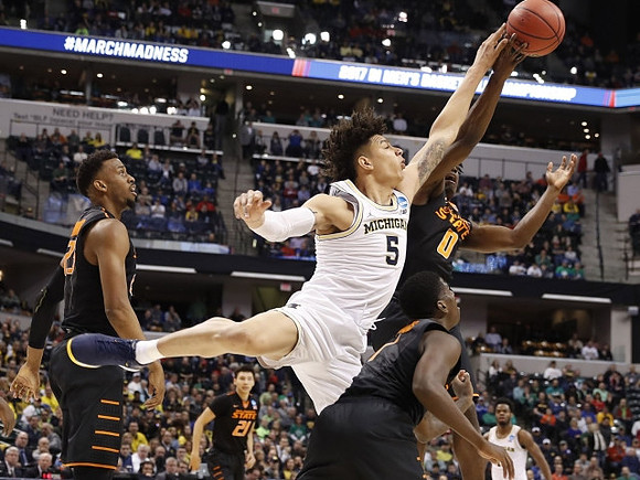D.J. Wilson (5) and Derrick Walton Jr. (10)